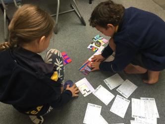 1 Nikea and Onyx try to put the postcards together